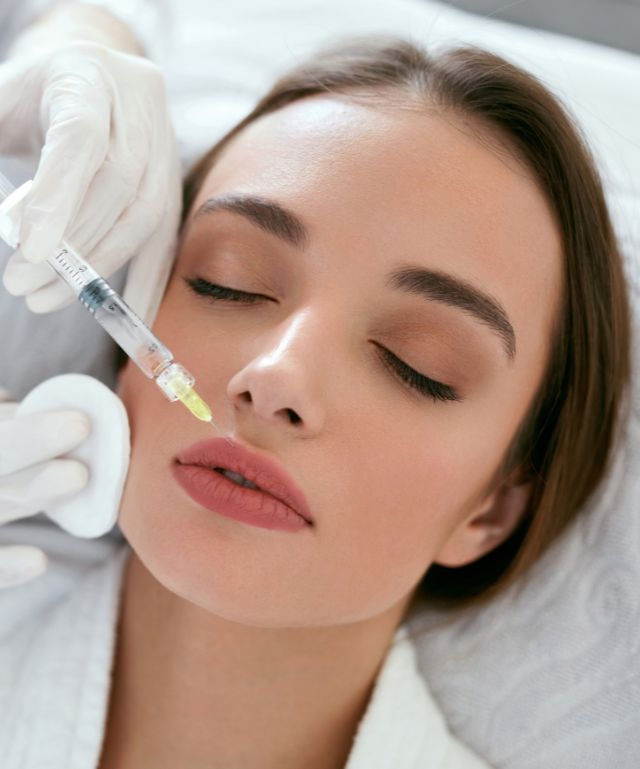 A picture of a woman receiving a lip filler injection in Centennial, CO