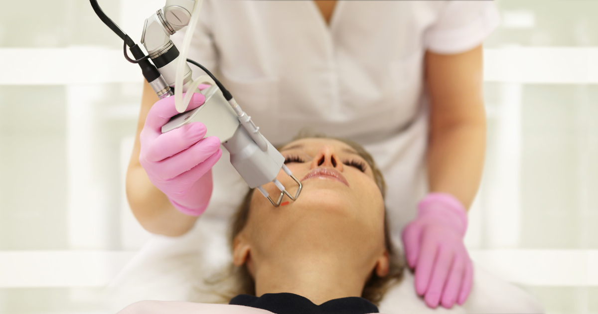 A woman getting CO2 facial treatment.